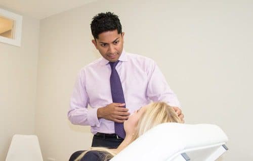 Mr Karri examining a patient at The Karri Clinic
